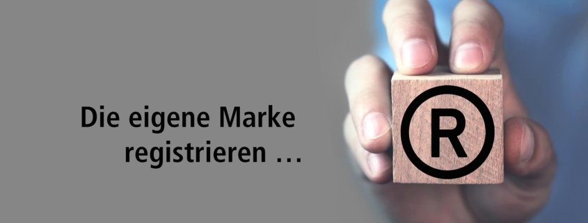 Die eigene Marke registrieren mit Hand, die Würfel mit Aufdruck Registered Trademark hält.